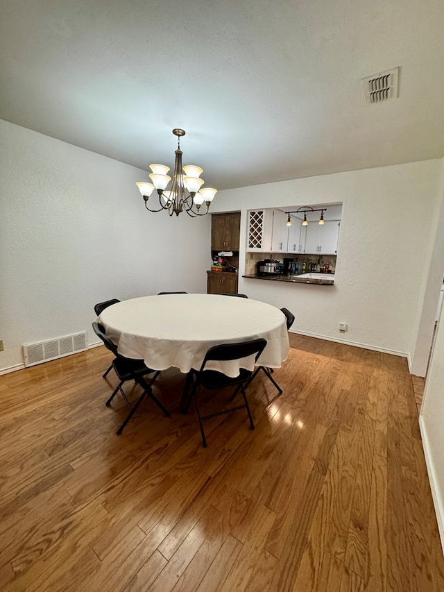 5214 Green Valley Trl, San Angelo, TX 76904 - dining area featuring wood finished floors and a chandelier
