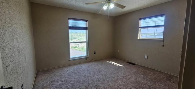 1210 Elizabeth St, Rankin, TX 79778 - carpeted empty room featuring healthy amount of natural light, ceiling fan, and a textured ceiling