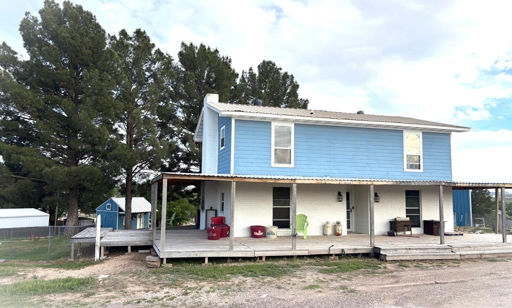 1210 Elizabeth St, Rankin, TX 79778 - farmhouse with fence, metal roof, and an outbuilding