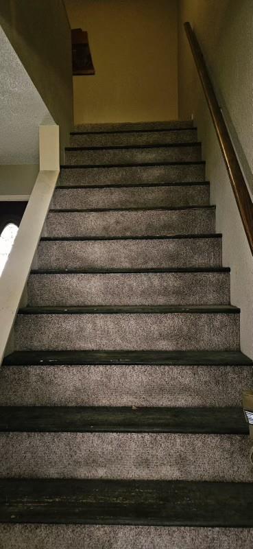 1210 Elizabeth St, Rankin, TX 79778 - staircase featuring a textured ceiling