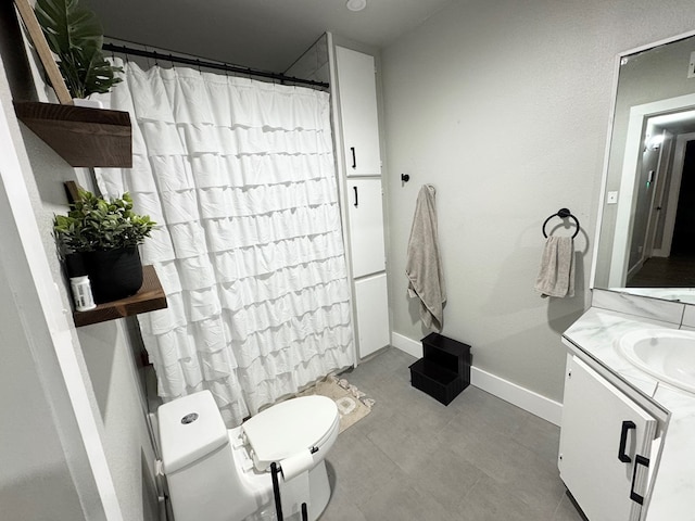 411 N Bishop St, San Angelo, TX 76901 - bathroom featuring vanity, toilet, baseboards, and a shower with shower curtain