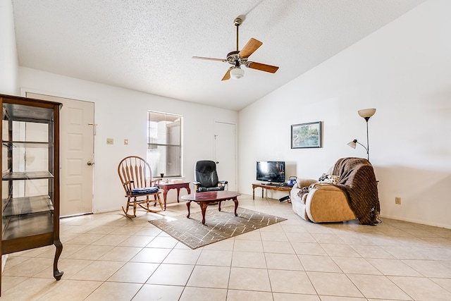 tiled living room with ceiling fan, lofted ceiling, and a textured ceiling