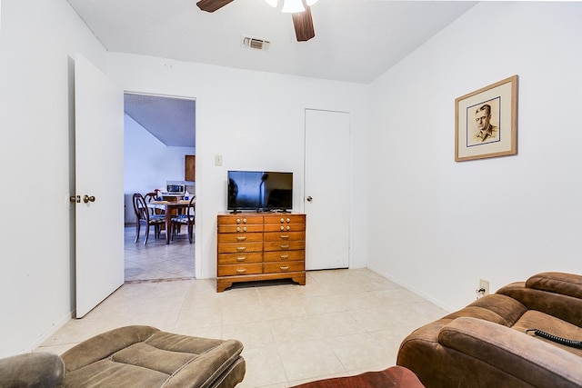 tiled living room featuring ceiling fan