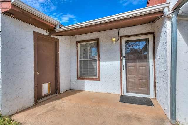 property entrance featuring a patio