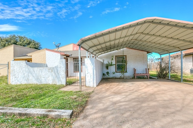 exterior space with a carport and a front lawn