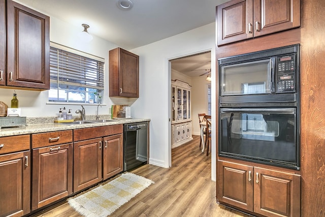 2805 Alta Vista Ln, San Angelo, TX 76904 - kitchen featuring black appliances, light wood finished floors, and light stone countertops