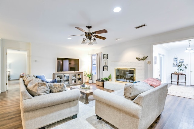 2805 Alta Vista Ln, San Angelo, TX 76904 - living room with a ceiling fan, ornamental molding, wood finished floors, a brick fireplace, and recessed lighting