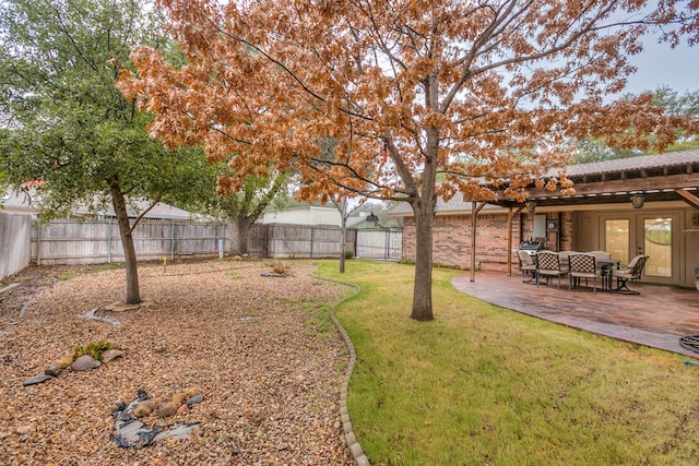 2805 Alta Vista Ln, San Angelo, TX 76904 - fenced backyard featuring french doors and a patio