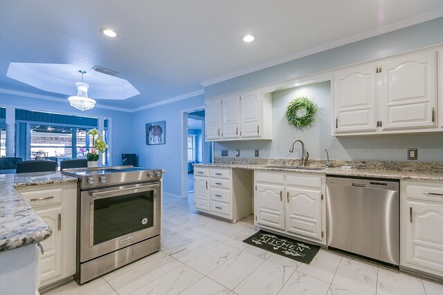 kitchen with appliances with stainless steel finishes, sink, and white cabinets