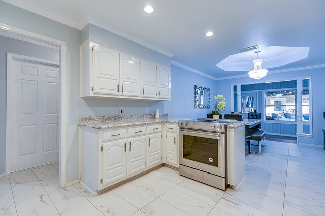 kitchen with stainless steel electric range oven, pendant lighting, white cabinets, light stone counters, and kitchen peninsula