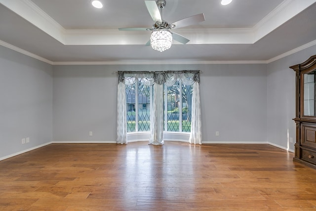 unfurnished room with ornamental molding and a tray ceiling