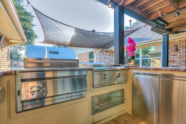 view of patio with an outdoor kitchen and a grill