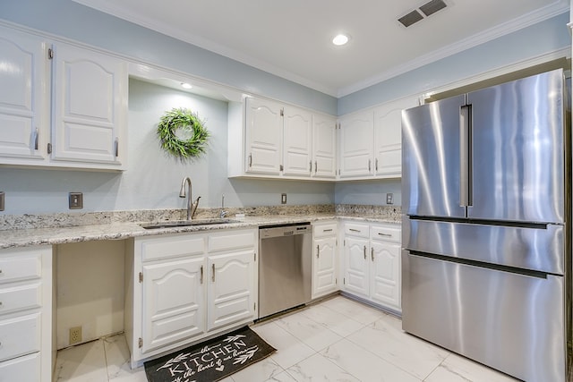 kitchen featuring white cabinetry, sink, stainless steel appliances, and light stone countertops