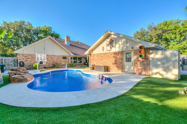 view of swimming pool with a lawn and a patio area