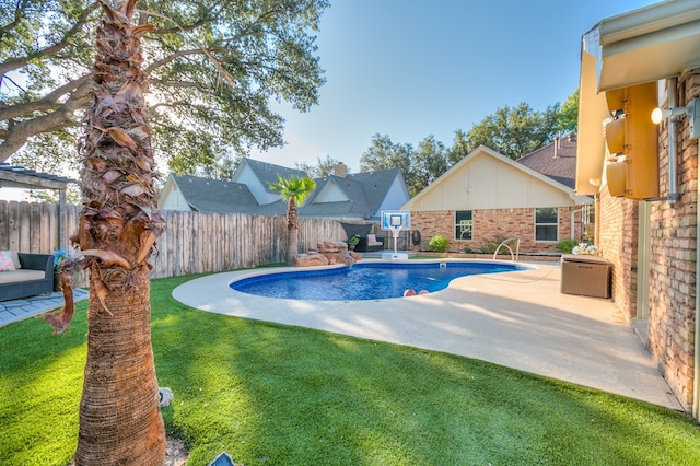 view of swimming pool featuring a lawn and a patio area