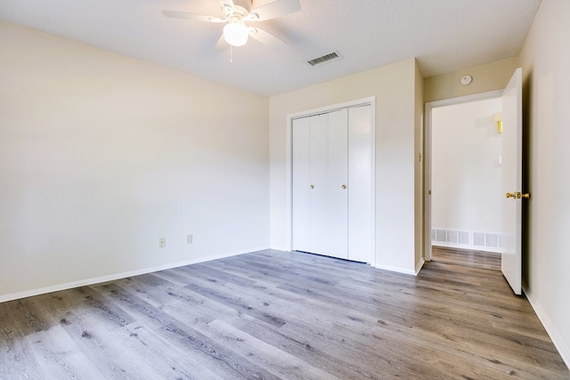 2410 Louise Dr, San Angelo, TX 76901 - unfurnished bedroom featuring wood finished floors, baseboards, a closet, and ceiling fan