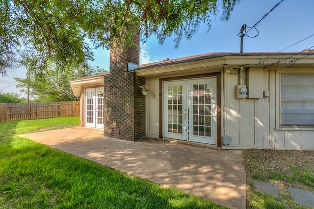 2410 Louise Dr, San Angelo, TX 76901 - back of house with french doors, a patio, a chimney, and board and batten siding