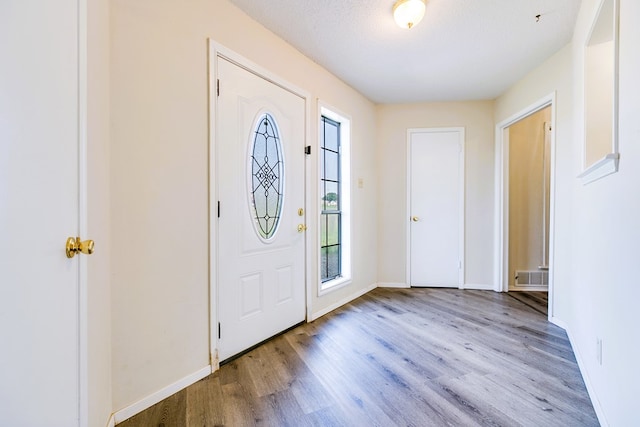 2410 Louise Dr, San Angelo, TX 76901 - entryway with wood finished floors, healthy amount of natural light, and baseboards