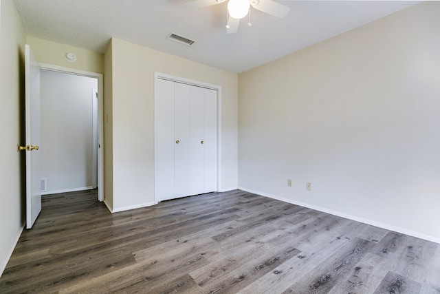2410 Louise Dr, San Angelo, TX 76901 - unfurnished bedroom featuring wood finished floors, a closet, baseboards, and ceiling fan