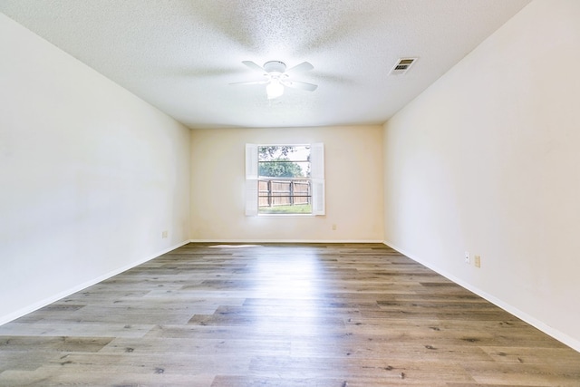 2410 Louise Dr, San Angelo, TX 76901 - unfurnished room with ceiling fan, wood finished floors, a textured ceiling, and baseboards