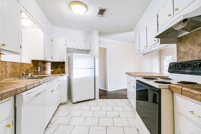 2410 Louise Dr, San Angelo, TX 76901 - kitchen featuring white appliances, under cabinet range hood, white cabinetry, a sink, and backsplash