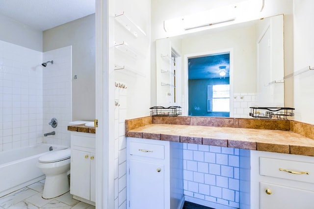 2410 Louise Dr, San Angelo, TX 76901 - bathroom featuring vanity, shower / bathtub combination, toilet, and marble finish flooring