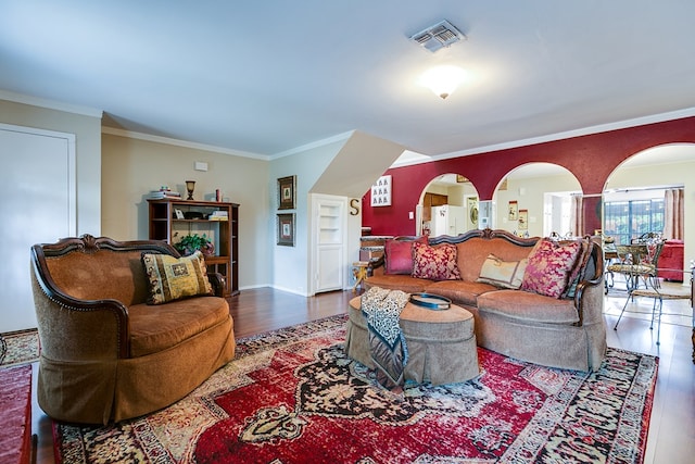 4918 Blue Ridge Trl, San Angelo, TX 76904 - living area featuring arched walkways, visible vents, ornamental molding, and wood finished floors