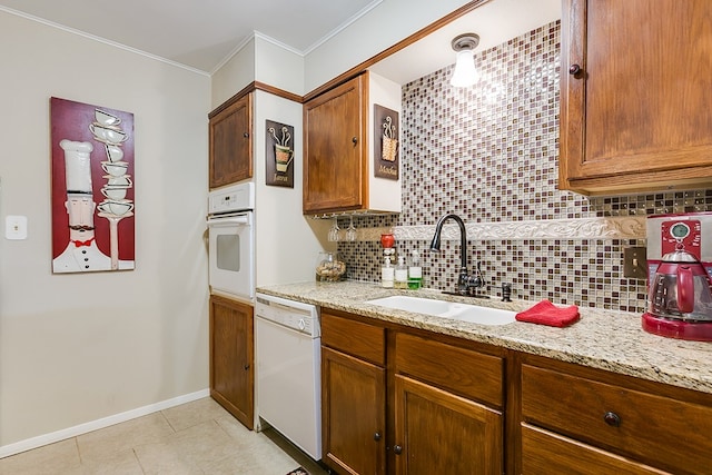 4918 Blue Ridge Trl, San Angelo, TX 76904 - kitchen with ornamental molding, white appliances, a sink, backsplash, and light tile patterned floors