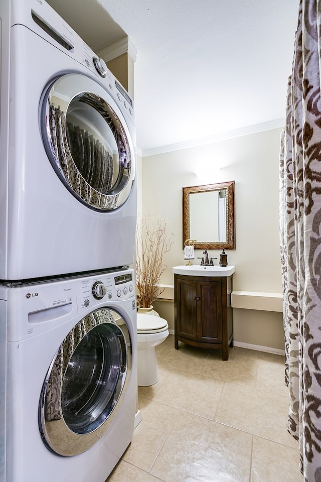 4918 Blue Ridge Trl, San Angelo, TX 76904 - interior space with crown molding, stacked washer and dryer, laundry area, and light tile patterned floors