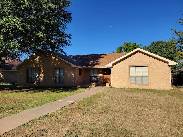 ranch-style home with a front lawn