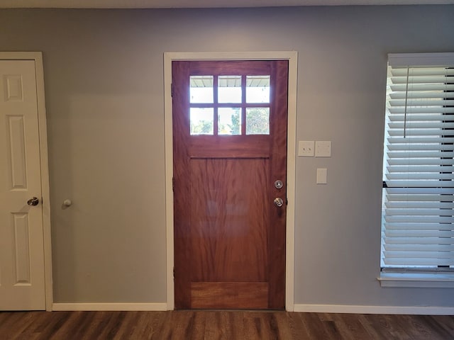 foyer entrance featuring baseboards and dark wood-style flooring