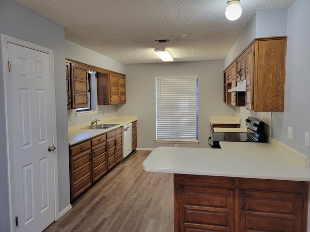 kitchen featuring visible vents, light countertops, electric stove, white dishwasher, and a sink