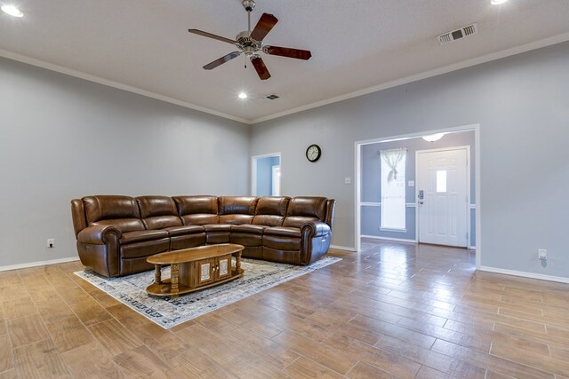 living room featuring crown molding, ceiling fan, and light hardwood / wood-style floors