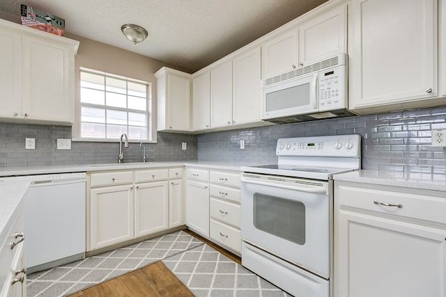 4929 Royal Oak Dr, San Angelo, TX 76904 - kitchen with white cabinetry, white appliances, light hardwood / wood-style floors, and sink