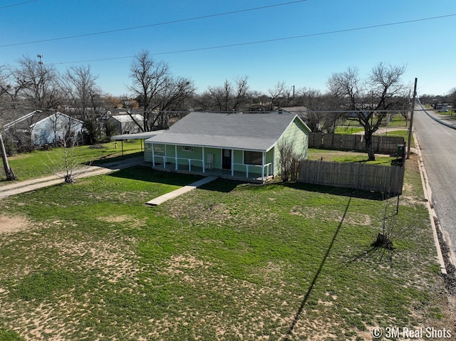 view of front of property featuring a front yard, a carport, and covered porch