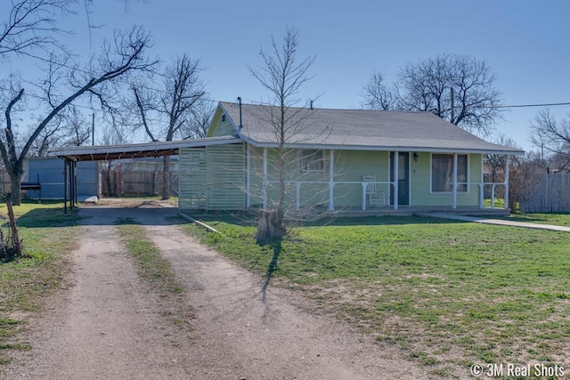 view of front of property with a porch, a carport, and a front lawn