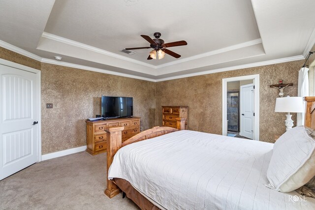 carpeted bedroom featuring a raised ceiling, ornamental molding, and ceiling fan