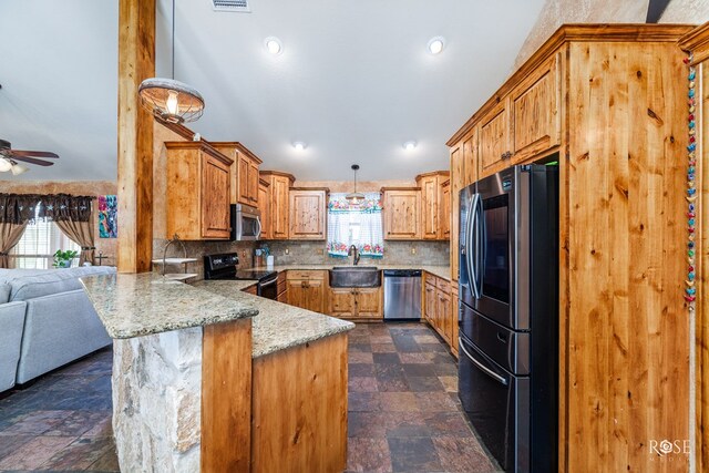 kitchen with sink, stainless steel appliances, tasteful backsplash, decorative light fixtures, and kitchen peninsula