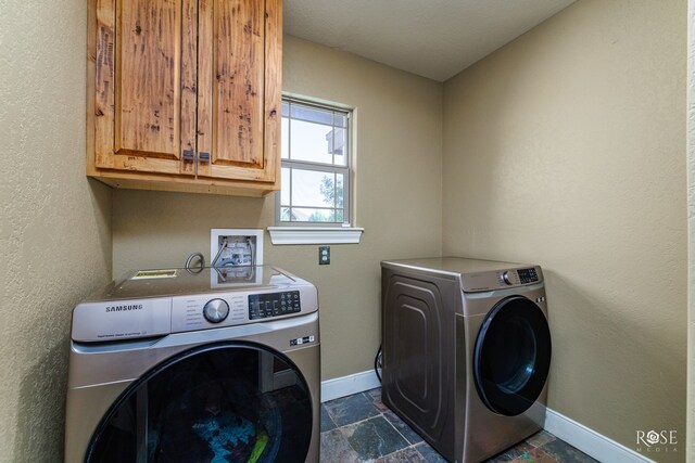 laundry room featuring cabinets and separate washer and dryer