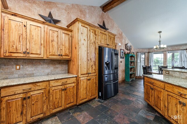 kitchen featuring pendant lighting, vaulted ceiling with beams, light stone countertops, and stainless steel refrigerator with ice dispenser