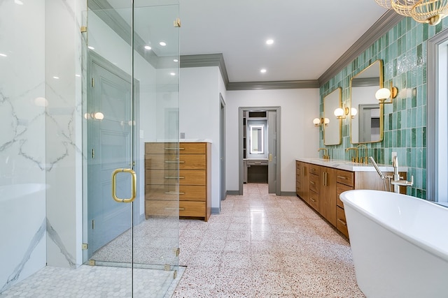full bathroom featuring a shower stall, vanity, crown molding, baseboards, and a freestanding tub