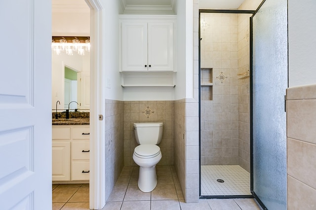 full bath featuring tile patterned floors, toilet, a shower stall, vanity, and ornamental molding