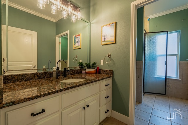 bathroom with tile patterned flooring, vanity, crown molding, and a shower with door