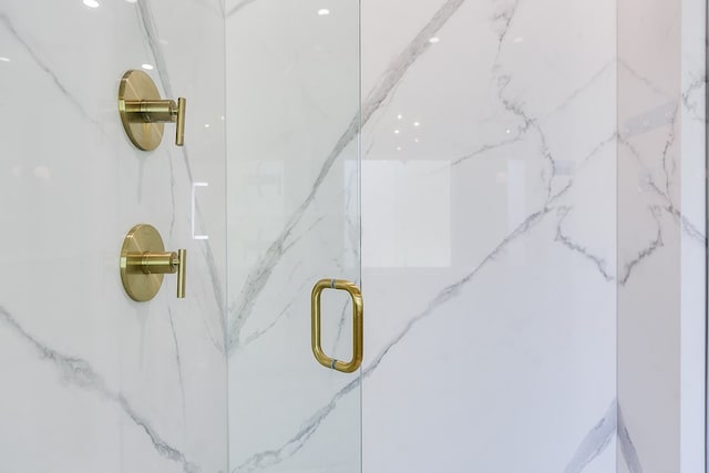 room details featuring a marble finish shower