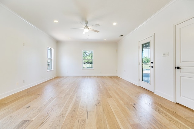 spare room with a ceiling fan, baseboards, ornamental molding, and light wood finished floors