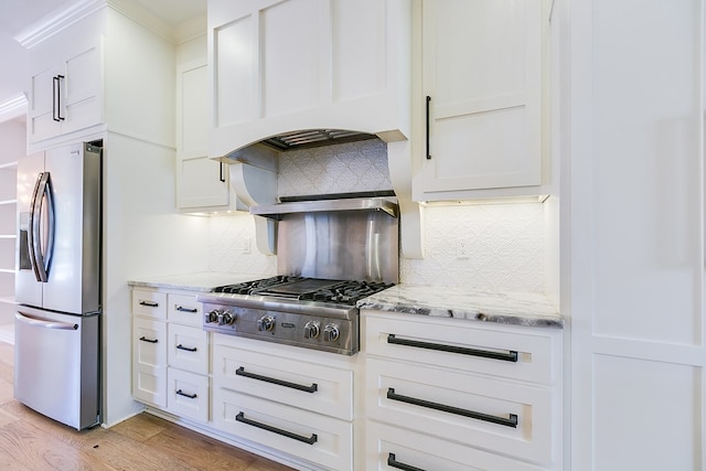 kitchen with premium range hood, decorative backsplash, appliances with stainless steel finishes, and white cabinets