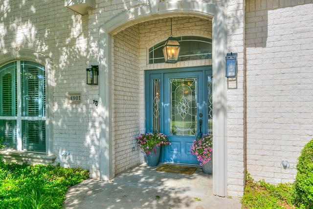 doorway to property with brick siding