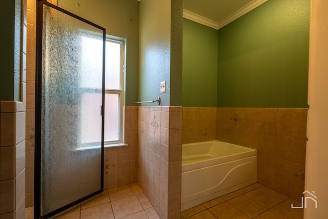 bathroom featuring ornamental molding, a washtub, tile walls, and tile patterned floors