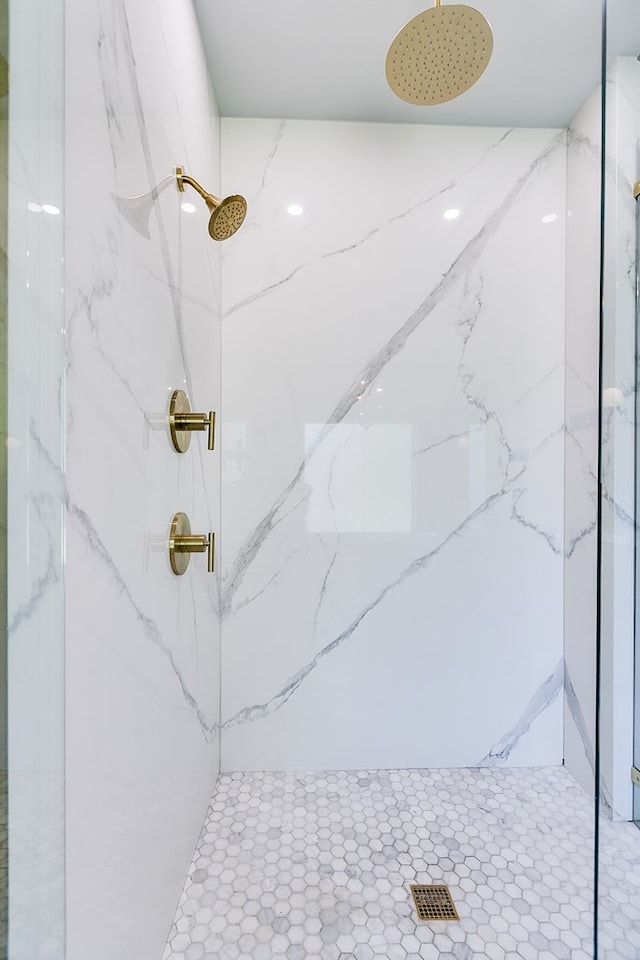 bathroom featuring a marble finish shower