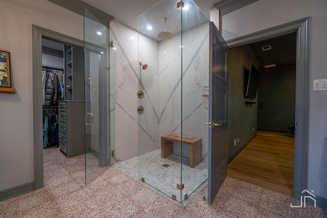 bathroom featuring a shower with door